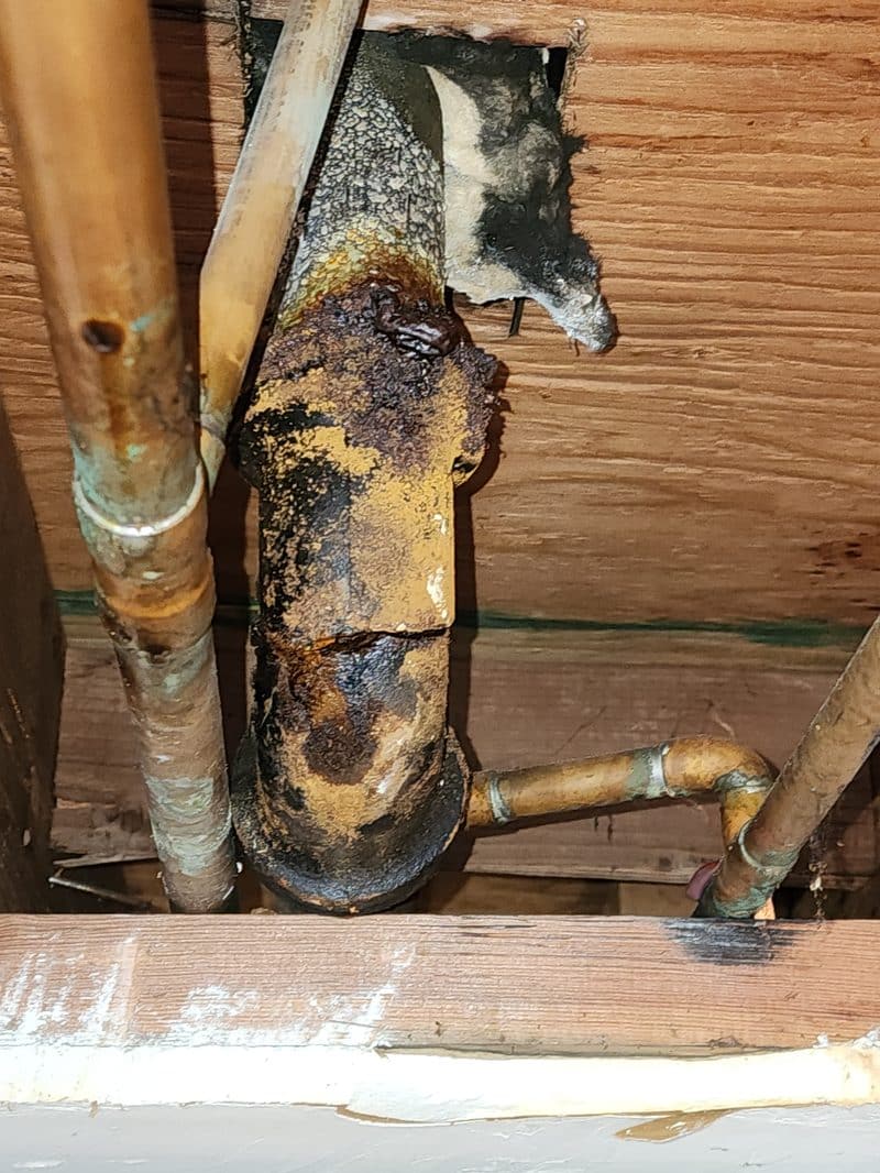free-second-opinion-corroded-cast-iron-drain-orange-county Severely corroded cast iron drain pipe inside a wall cavity, the kind of damage that genuinely needs full replacement