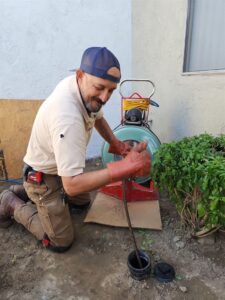 A technician snaking a main line at a Fountain Valley home during second opinion diagnostic work