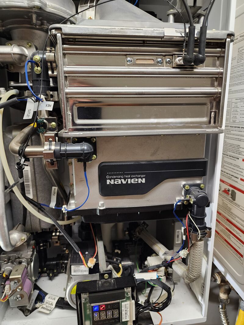 navien-tankless-heat-exchanger-internal-view The stainless heat exchanger inside a Navien tankless. An undersized gas line lets combustion go incomplete and bonds soot to this surface, voiding the warranty.