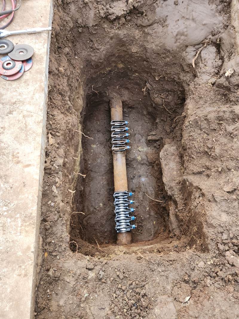 repair-service-galvanized-water-line-repair-clamp-orange-county Underground water-line repair with a large-diameter repair clamp on a galvanized supply line at an Orange County property