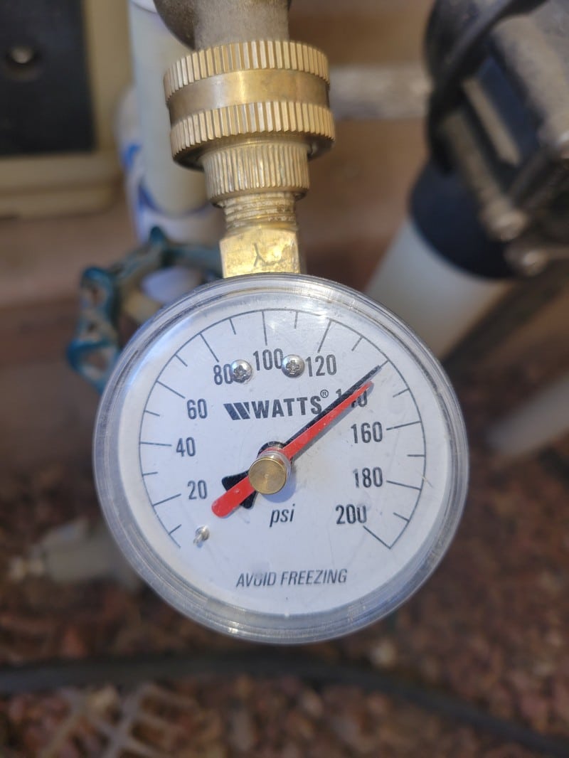 repair-service-high-water-pressure-gauge-reading Pressure gauge reading 140 psi at a hose bib during a pressure-regulator diagnostic at an Orange County home